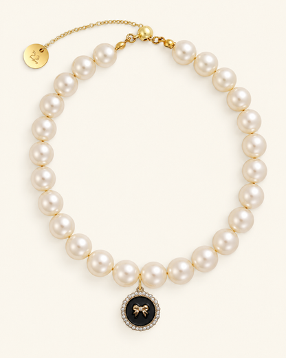 Faux pearl necklace for cats with a black bow charm and gold clasp
