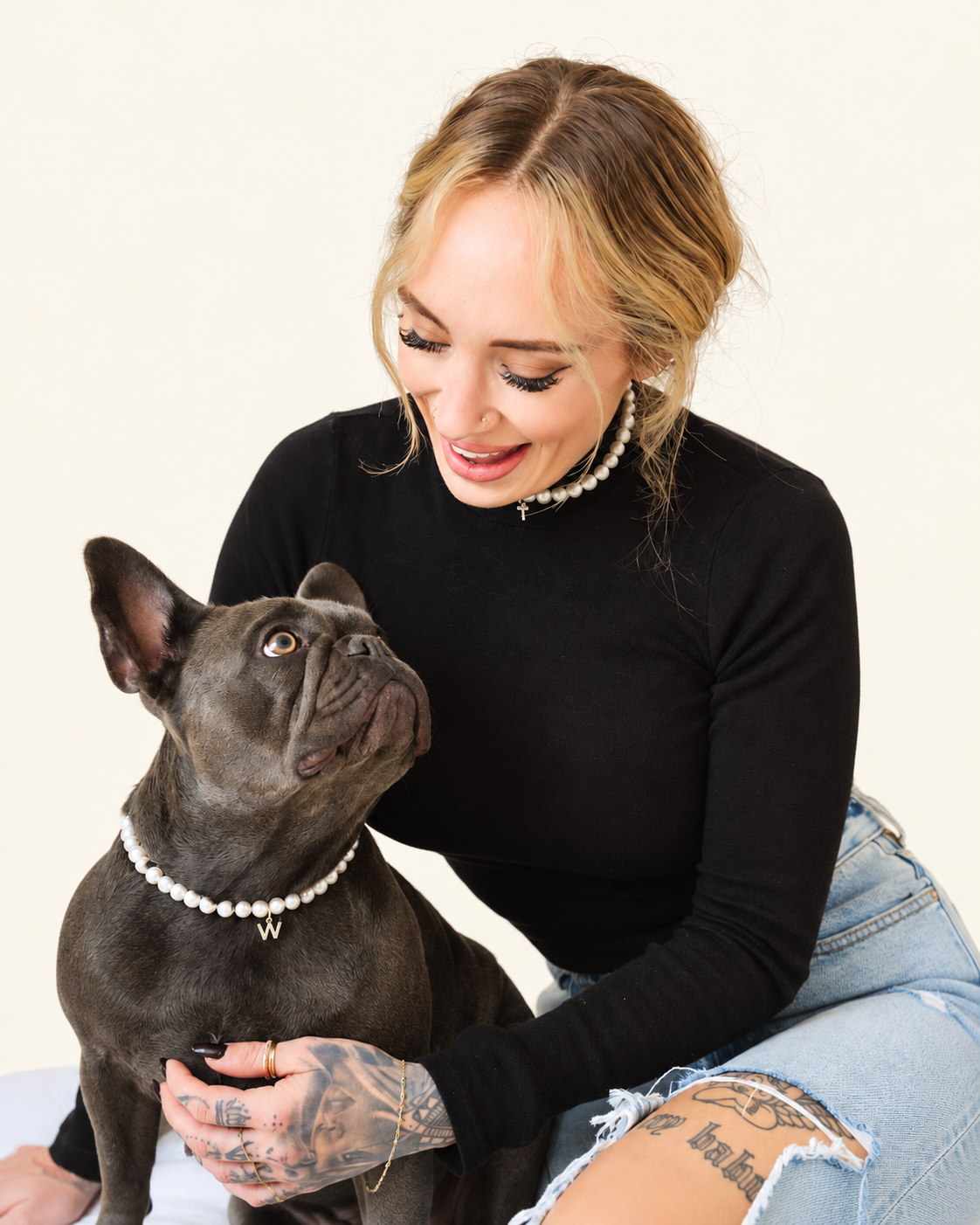 Woman and her French bulldog wearing matching freshwater pearl necklaces